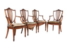 A set of four oak and upholstered armchairs in George III style