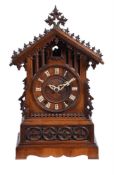 A carved oak and pine mantel clock of Black Forest type