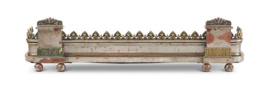 A REGENCY STYLE STEEL AND BRASS MOUNTED FENDER