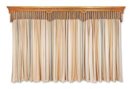 A CARVED GILTWOOD PELMET TOGETHER WITH A SET OF FOUR CURTAINS
