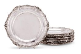 A matched set of twelve Victorian silver shaped circular dinner plates