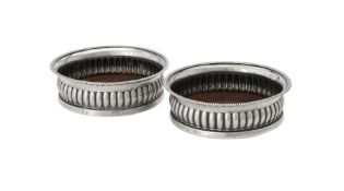 A pair of George III silver mounted wine coasters by John Roberts & Co.