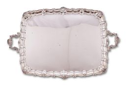 An Edwardian silver shaped rectangular twin handled tray by Wakely & Wheeler (James Wakely & Frank C