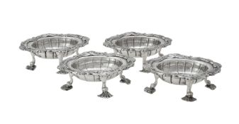 A set of four George II silver shaped oval salts by David Hennell I