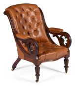 An early Victorian mahogany and buttoned leather upholstered library armchair