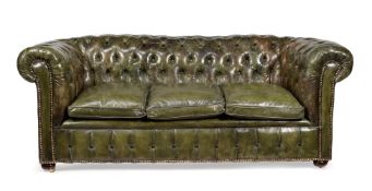 A green leather upholstered sofa