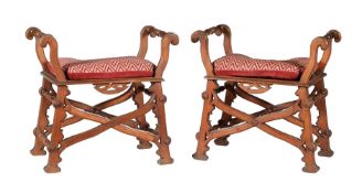 A pair of Reformed Gothic walnut X-framed stools or window seats