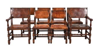 A set of eight oak and brass studded brown leather upholstered dining chairs