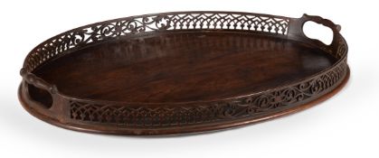 A GEORGE III MAHOGANY OVAL TRAY, IN THE MANNER OF THOMAS CHIPPENDALE, CIRCA 1770