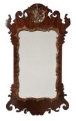 A GEORGE II WALNUT AND PARCEL GILT WALL MIRROR, CIRCA 1755