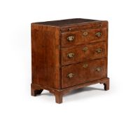 A GEORGE II WALNUT, FEATHER BANDED AND CROSS BANDED CHEST OF DRAWERS