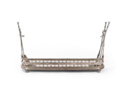 A POLISHED STEEL FIREPLACE FENDER WITH SET OF FOUR FIRE TOOLS, MID 19TH CENTURY
