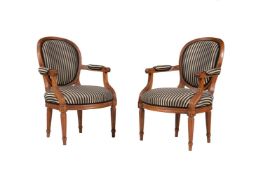 A PAIR OF WALNUT AND UPHOLSTERED FAUTEUILS, IN LOUIS XVI STYLE