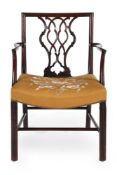 A GEORGE III MAHOGANY AND UPHOLSTERED OPEN ARMCHAIR, IN THE MANNER OF THOMAS CHIPPENDALE, CIRCA 1775