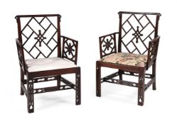 A PAIR OF GEORGE III MAHOGANY COCKPEN ARMCHAIRS IN THE CHINESE CHIPPENDALE MANNER, CIRCA 1770