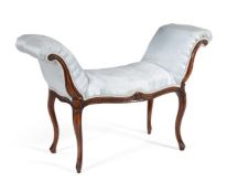 A GEORGE III MAHOGANY AND UPHOLSTERED WINDOW SEAT IN THE MANNER OF GEORGE HEPPLEWHITE