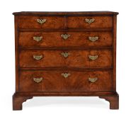 A GEORGE II WALNUT AND FEATHER BANDED CHEST OF DRAWERS, CIRCA 1740