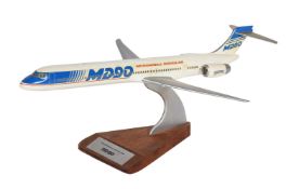 An aircraft manufacturers desk top model of a McDonnell Douglas MD90 passenger plane