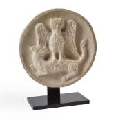 A LIMESTONE ROUNDEL OF AN OWL AND A LION, POSSIBLY 19TH CENTURY