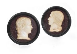 A PAIR OF ITALIAN WHITE MARBLE RELIEF PORTRAITS OF JULIUS CAESAR AND HIS WIFE CALPURNIA