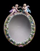 A Meissen flower encrusted and gilt metal mounted oval strut looking glass