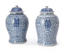 A pair of Chinese blue and white 'marriage' vases and covers
