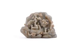 A Chinese celadon jade carving of two scholars playing go under the pine tree
