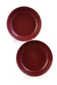 A pair of Chinese copper-red saucer dishes