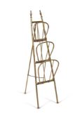AN UNUSUAL EDWARDIAN GILT BRASS MAGAZINE RACK, CIRCA 1905
