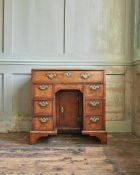 A GEORGE II BURR WALNUT, WALNUT AND FEATHER BANDED KNEEHOLE DESK, CIRCA 1735