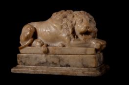 AN ITALIAN CARVED MARBLE MODEL OF A RECUMBENT LION AFTER ANTONIO CANOVA, EARLY 19TH CENTURY