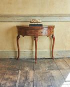 A WALNUT AND CHEVRON STRUNG DEMI-LUNE CARD TABLECIRCA 1710 AND LATERThe hinged top opening to a ba