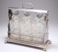 A LATE VICTORIAN SILVER-PLATED THREE-BOTTLE TANTALUS