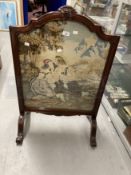 20th cent. Woolwork fire screen in ornate rosewood frame.