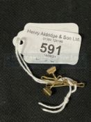 Jewellery: Yellow metal pair of dress studs each set with a single square cut green tourmaline,