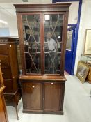 Early 20th cent. Mahogany two part bookcase, the thirteen pane glazed doors above two blind doors on