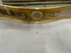 19th cent. Brass serpentine fender with pierced decoration and a central panel with a reef and a set