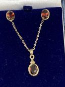 Hallmarked Jewellery: 9ct gold three-piece suite, pendant and earrings, set with single oval cut