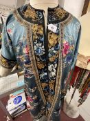 19th cent. Embroidered silk robe decorated with floral sprays and baskets of flowers on a light blue