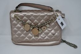 One pre-owned Guess Victoria Quilted Convertible Crossbody pink bag (VG710721. One scratch on the