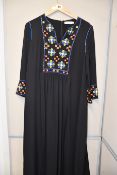 One pre-owned Tory Burch black tunic with strass decorations on the front. Size 8.