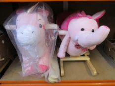 A boxed Labebe unicorn rocker and an unboxed Homcom 2 in 1 pink elephant rocking horse/baby ride.
