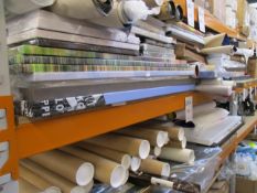 Two shelves of miscellaneous art/prints and related items.