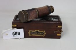 A Brass and leather three draw telescope by Dolland of London, the brass inscribed DOLLAND LONDON