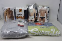 Three packs of Calvin Klein underwear (3 per pack), a pack of Hugo Boss crew neck T-shirts (S),
