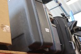 five empty suitcases/holdalls and a storage box.