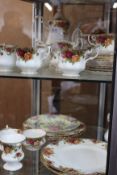A quantity of Royal Albert Country Roses to include teapot, coffee pot, sugar bowls tea/coffee cups,