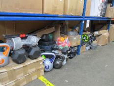 A large quantity of exercise equipment including kettle bells, dumbbells and dumbbell weights,