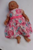 An as new weighted real life look alike baby girl doll.