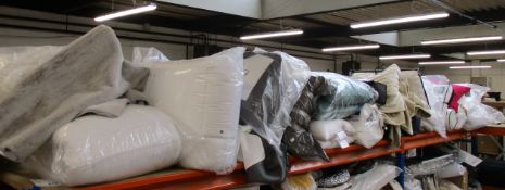 A large quantity of bedding, pillows, quilts, cushions and related items.